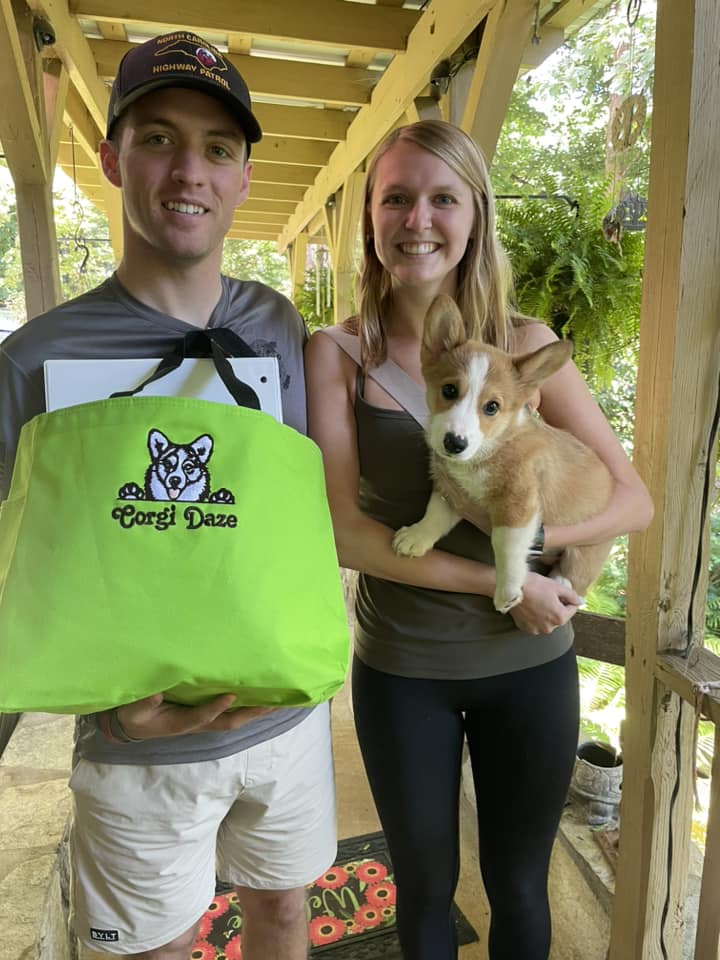 Family with new female red and white pembroke welsh corgi puppy in NC